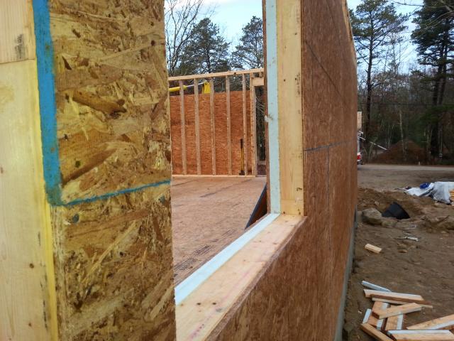 The high-efficiency wall insulation system uses rigid foam on the interior face of the framing to block heat loss and gain through the wood.