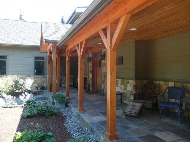 The home's dry-by-design wall construction includes structural insulated panel walls with sealed seams covered by corrugated house wrap and naturally durable stained cedar and stone cladding.