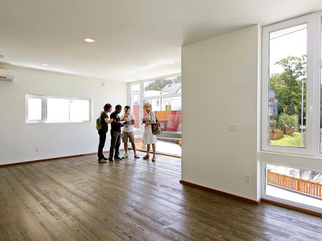 The single ultra-efficient ductless heat pump (10.6 HSPF, 23 SEER), shown mounted on the wall at the upper left, provides all the heating and cooling the 2,000-square-foot home needs. The heating and cooling requirements are substantially reduced by the 14-inch-thick double-wall thermal blanket construction with insulation and ultra-efficient triple-pane windows.