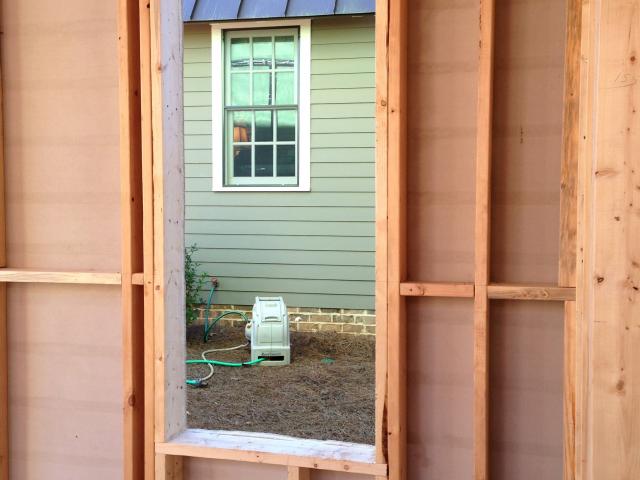 The high-efficiency window framing includes open headers above windows that allow space for insulation not possible with traditional solid wood beam window headers.