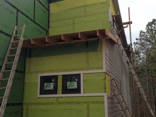 This complete dry-by-design wall includes a water barrier coated insulated sheathing taped at all seams with a moisture-resistant proprietary tape. This assembly is then wrapped with a breathable plastic mesh to form an air gap that ensures drying behind the exterior siding.