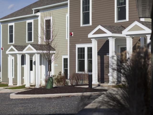 Durable fiber cement siding covers 2-by-6 wall panels that were produced offsite using high-efficiency advanced framing techniques including 2-stud corners, insulated headers, and ladder blocking at interior wall intersections. This reduces the amount of lumber used, leaving more room for insulation.