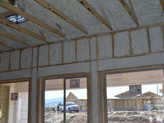 The continuous thermal blanket wall construction uses 3.5 inches of open-cell spray foam in the framed cavity along with an inch of rigid foam wrapped around the exterior sheathing.