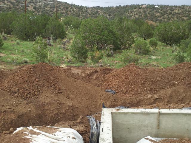 After pouring the foundation footings, energy-saving slab edge insulation is installed between the foundation wall and the slab. Radon vent piping is installed along the inside perimeter for health protection.