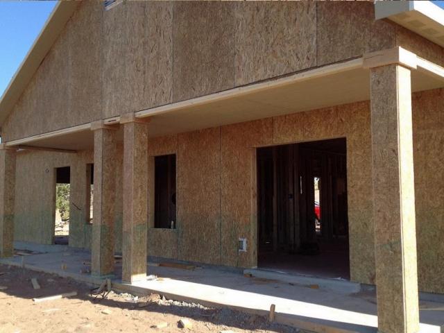 Oriented strand board, free of dangerous formaldehyde contaminants, sheaths the advanced framed walls.