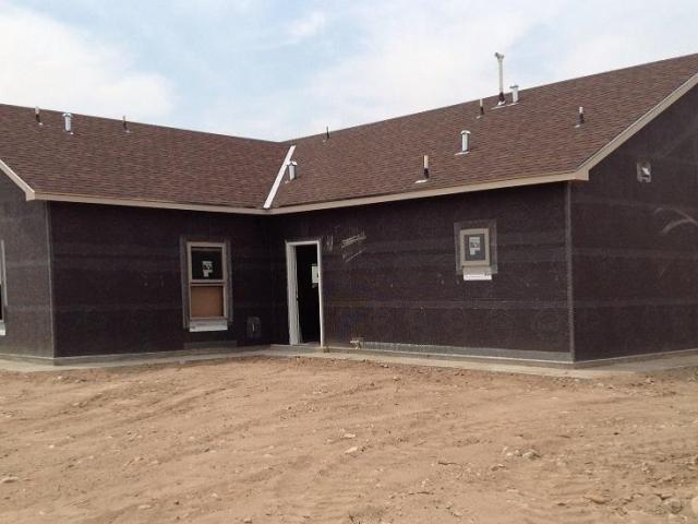 A double layer of building paper and proper flashing provides an effective wall water barrier system, while ice-and-water shield, more heavy-duty felt, and metal flashing provide an effective roof water barrier system. The underside of the roof is sprayed with a thick layer of open-cell spray foam providing a conditioned space for the interior comfort delivery system, providing heated and cooled air from an ultra-efficient heat pump (21 SEER / 10 HSPF).