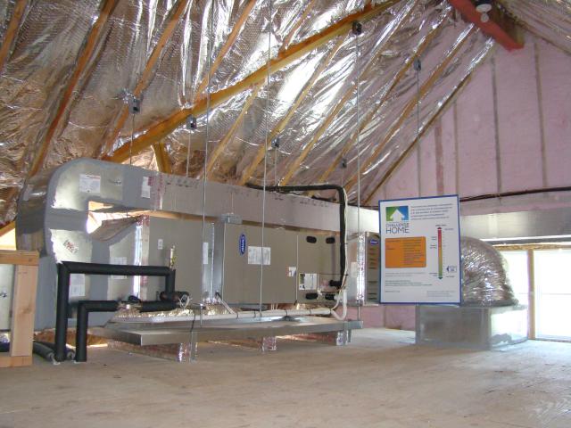 The unvented, insulated attic provides a conditioned space for the home's high-efficiency comfort system including two air handlers with ultra-efficient fans, a high-efficiency boiler, and a SEER 16 air conditioner. The ultra-efficient attic insulation (R-52.6) includes layers of closed-cell spray foam, mineral fiber batt insulation, and foil-faced fiberglass batt insulation.