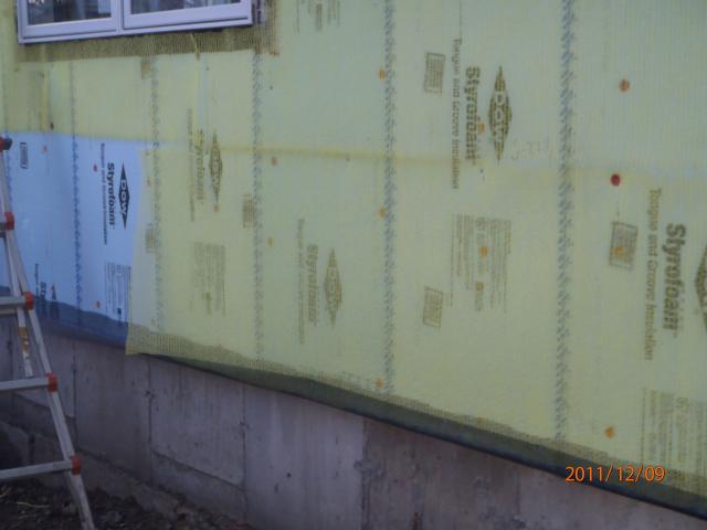 The coated roof and wall sheathing is taped at all seams as part of a comprehensive draft protection system.