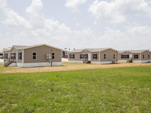 The high-efficiency DOE Zero Energy Ready Home was set up on Southern Energy Homes' property next to two identically sized homes, one constructed to the minimum HUD code and one to the ENERGY STAR Certified Homes criteria. DOE researchers will collect 15 months of data for a side-by-side-by-side comparison of energy efficient performance.