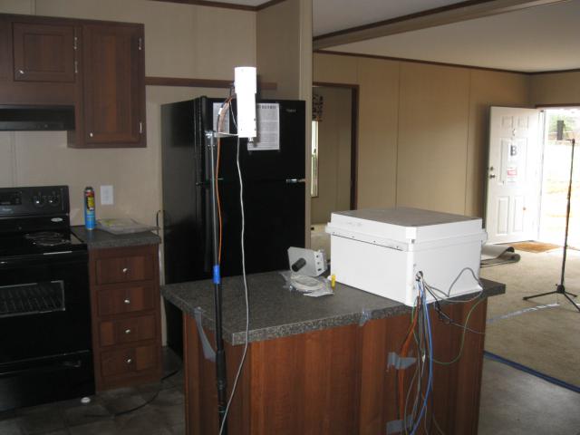 The test home is equipped with high-efficiency appliances including an ENERGY STAR-labeled dishwasher, clothes washer, and refrigerator shown here being monitored for energy and water use as part of the DOE research study.