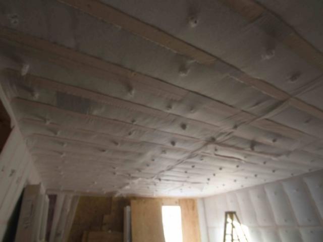 The 2-by-6 advanced-framed walls were dense-packed with R-23 of fiberglass insulation then wrapped with a continuous exterior thermal blanket of coated rigid foam insulation (R-23). The wall water barrier system includes taped house wrap over the taped rigid foam. Vertical furring strips were installed to provide a drainage gap behind the engineered wood siding as part of the dry-by-design wall construction.