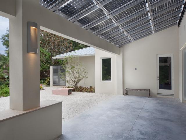 The 13.4-kW solar electric system forms the roof of the back porch. The panels are dual surface, meaning they produce power from any sunlight that hits the top of the panels as well as from any light reflected onto their lower surface from below, for up to 30% greater power production. All wiring is hidden within the canopy’s aluminum support beams.