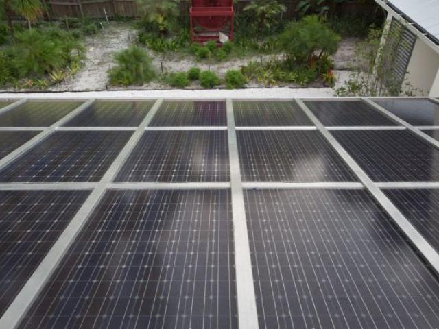 The home’s porch roof consists of 69 solar panels. The panels don’t sit on top of the roof; they are the roof. The panels are fitted together into a completely water-tight 962-square-foot roof structure that blocks the rain but allows about 15% of the light to filter through to the porch area below.