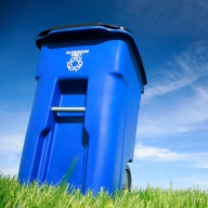 A blue recycling bin