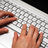 Image of fingers typing on a keyboard